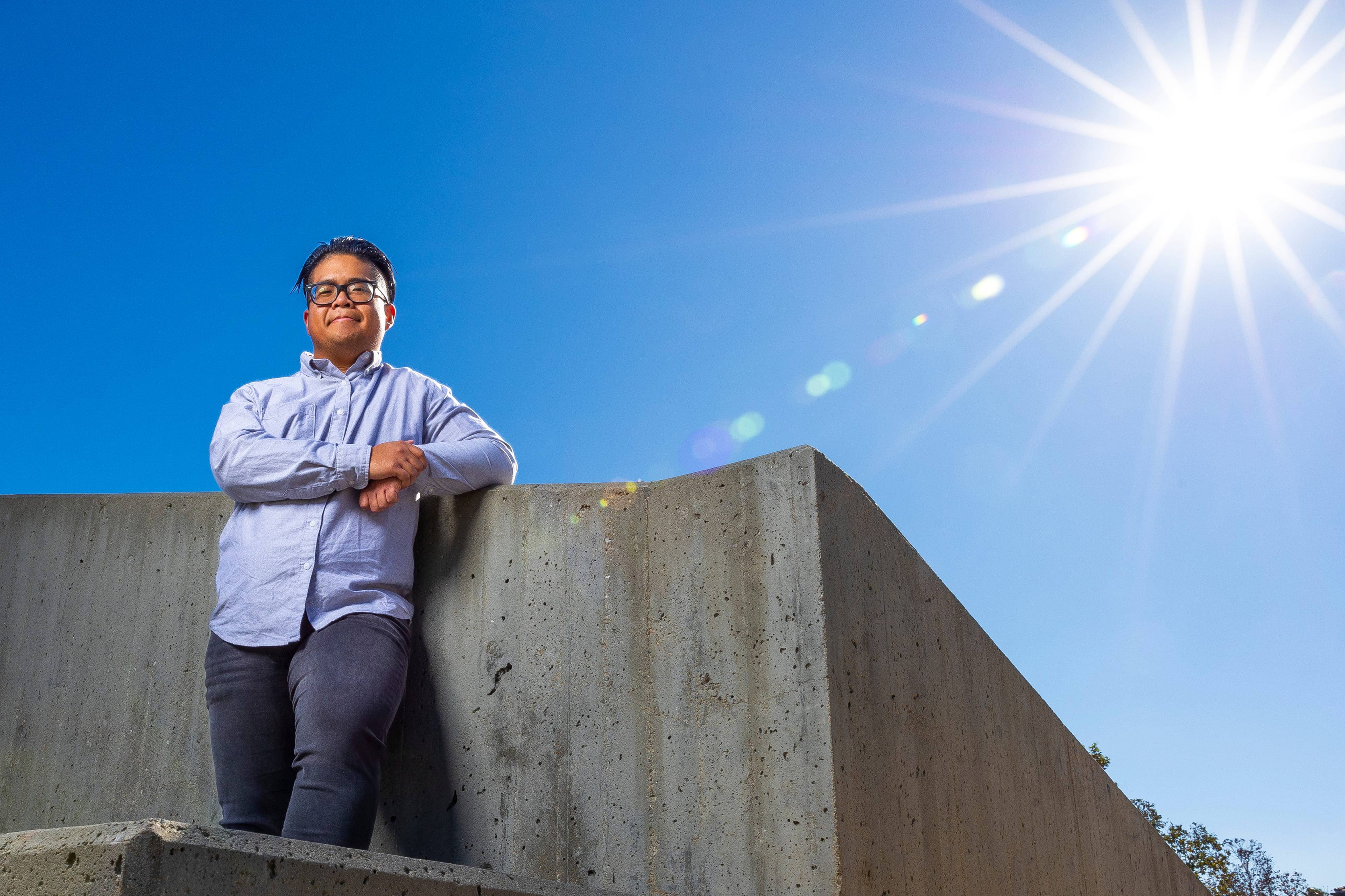 a person leaning on a concrete wall